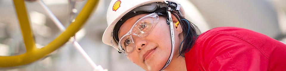 female employee inspecting equipment