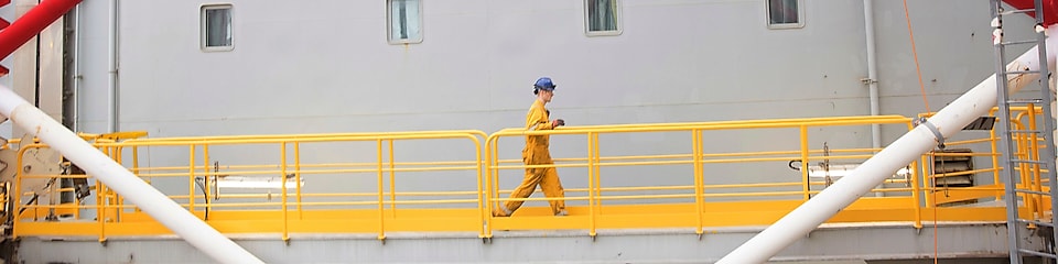 Engineer walking across a North sea offshore platform in Aberdeen