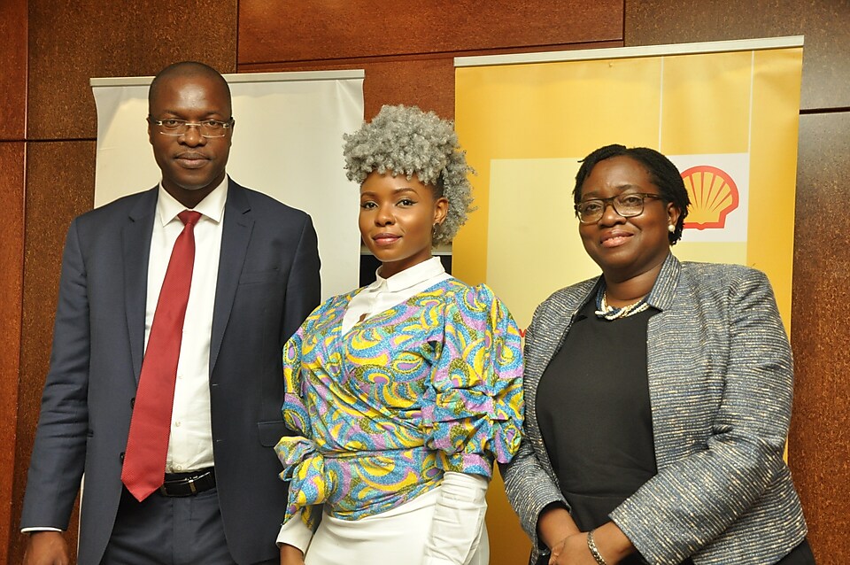 Three people posing for a group photo at a pre-launch media engagement