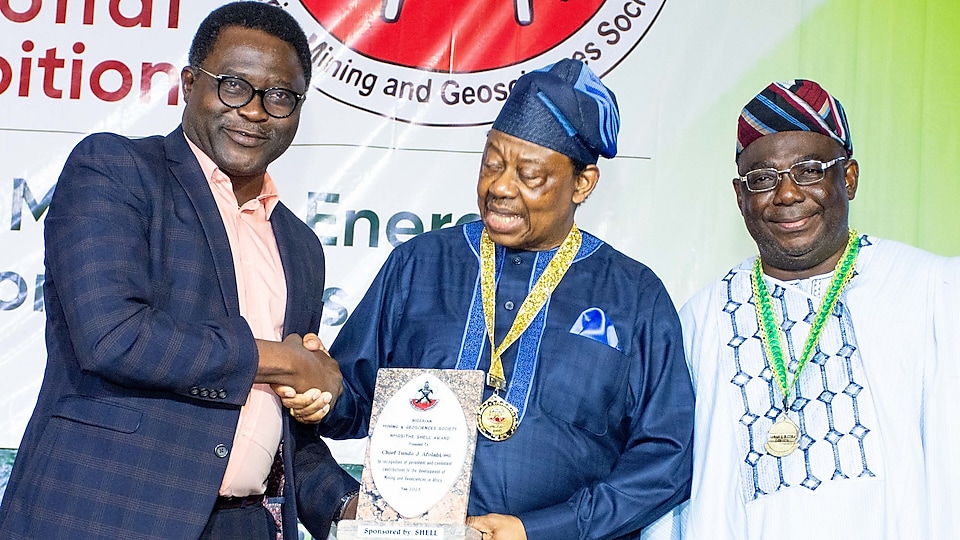 The Nigerian Mining and Geosciences Society (NMGS) has announced Chief Tunde Afolabi, MFR, as winner of the NMGS highest award for 2025, the NMGS/Shell Award at the 60th NMGS Annual International Conference and Exhibition in Abuja. The winner, Chief Afolabi (centre) receiving his award from Shell Head Specialist Geologist, Segun Obilaja (left) while the NMGS President, Professor Akinade Shadrach Olatunji, right, watches on.